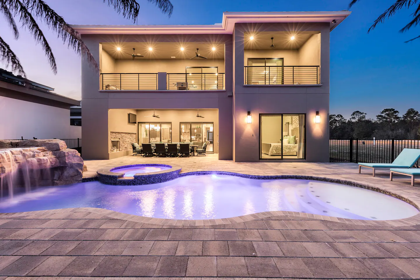 The property has a big private pool with a waterfall and grotto, overflow spa, grand patio area and veranda with a summer kitchen, fireplace, and outdoor TV for hours of fun in the sun.