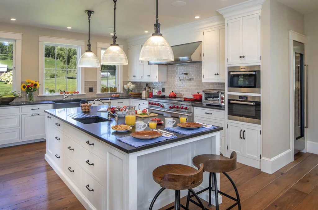 A stunning kitchen with a 62" Sub-Zero refrigerator/freezer and a complementary 60" dual fuel Wolf stove.