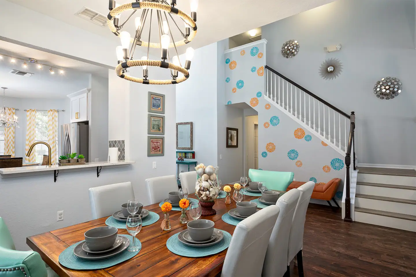 The formal dining space is furnished with a spacious, farmhouse-style table and cozy seating for a group of eight individuals, creating an inviting setting for a family gathering to savor a meal.