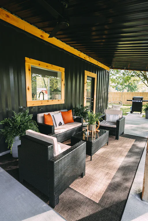 Our rear patio is covered and equipped with nice patio chairs, a hot tub, and a macrame swing.