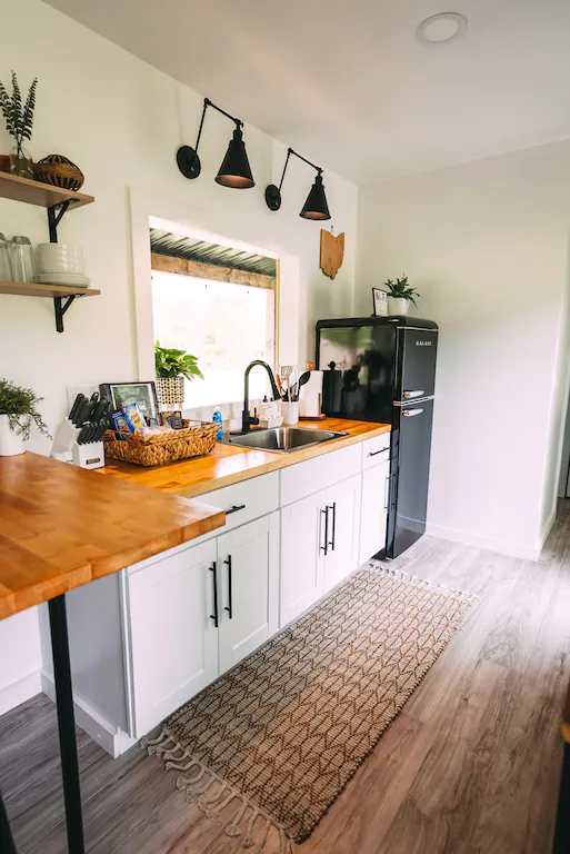 We provide a well-equipped kitchen with an induction cook top, toaster oven, microwave, and small refrigerator with freezer.