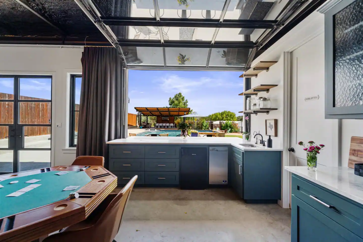 The Pool House offers a seamless transition between indoor and outdoor living spaces.