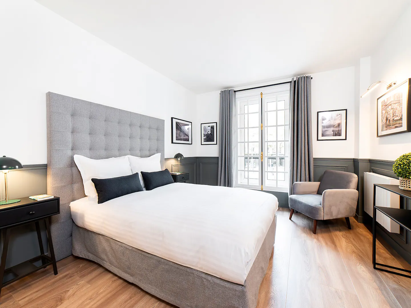 First bedroom with double bed, linen and working space