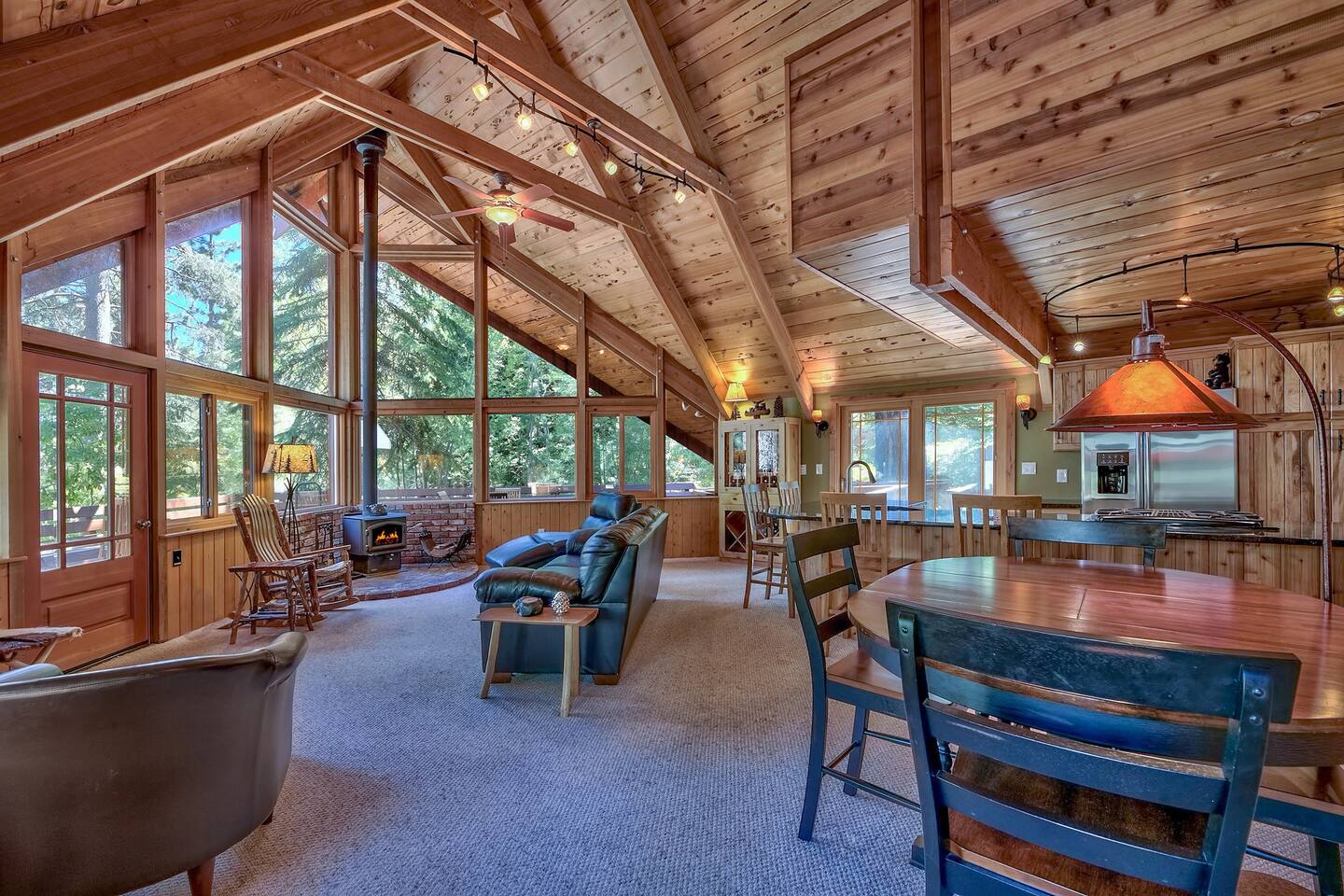 Relaxing living room with comfy couches looking out the giant windows at the trees.